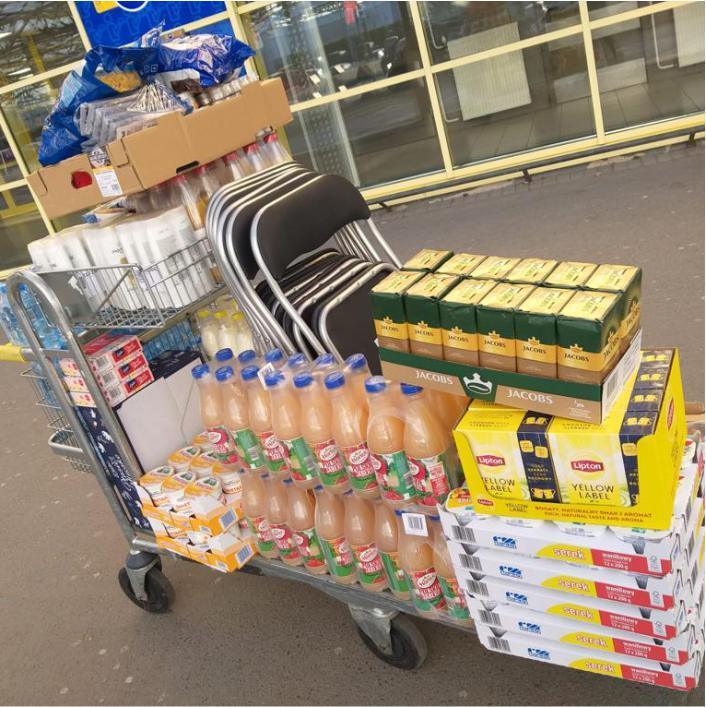 grocery cart filled with essential foods and supplies