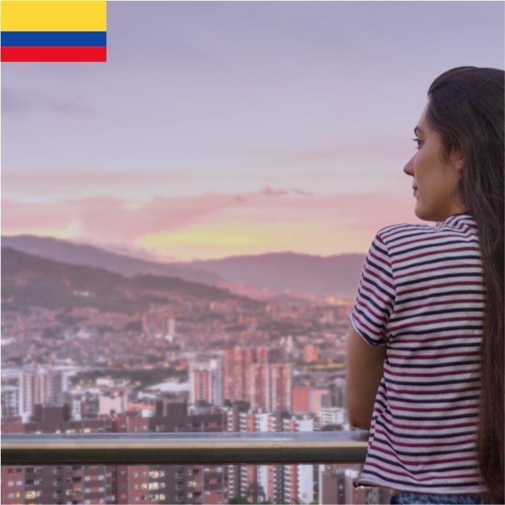 Woman looking out over the city of Medellin Colombia